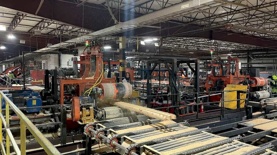 Material exiting the Wood-Mizer MR6000 gang saw